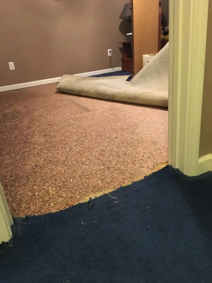 Carpet pad removal revealing water damage during Water Mitigation Services in South El Monte